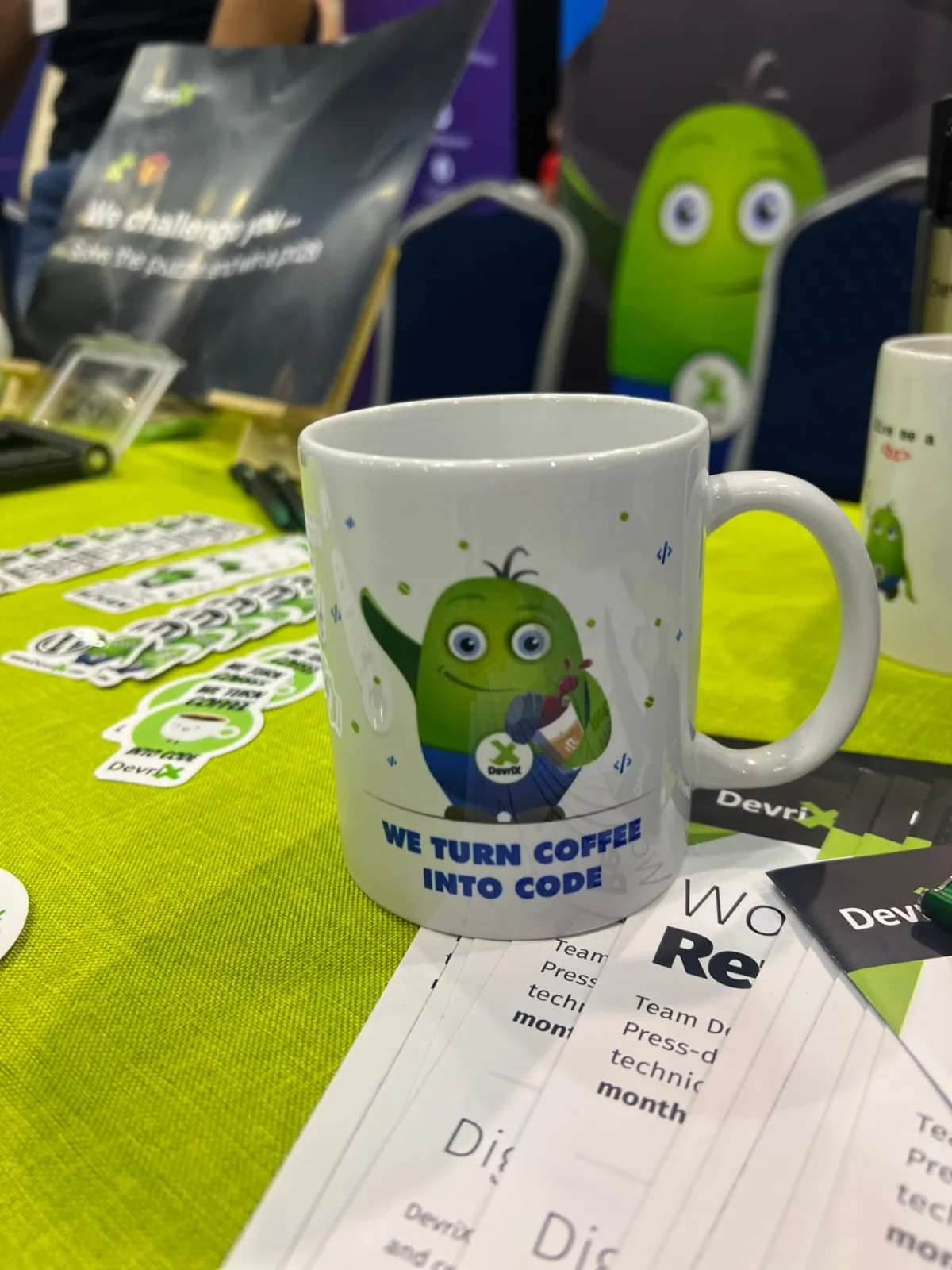 Conference booth with DevriX mascot mug and swag table
