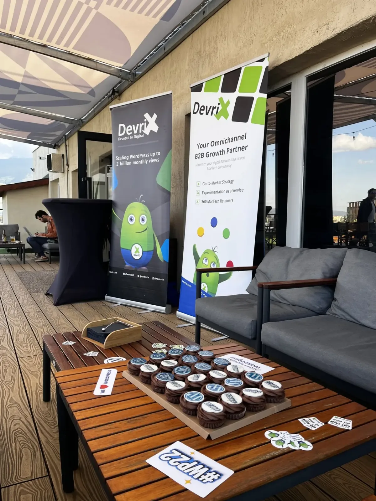 WordPress birthday rooftop meetup with DevriX banners and cupcakes