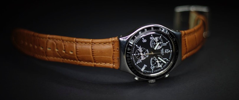 Wristwatch with black dial and brown leather straps