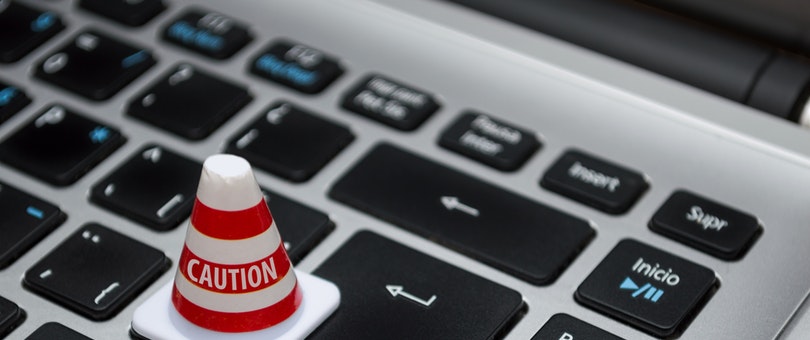 traffic cone toy placed on keyboard laptop